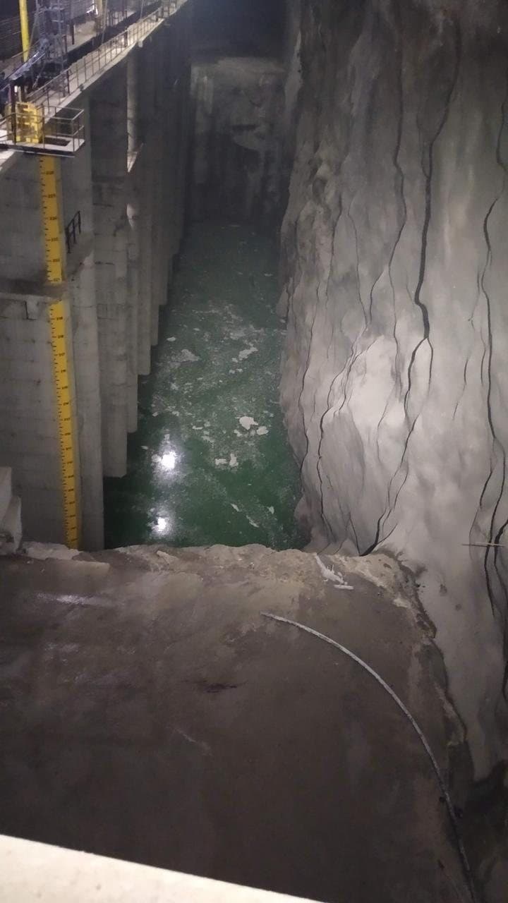 Deep water channel cut into rock with a narrow walkway above