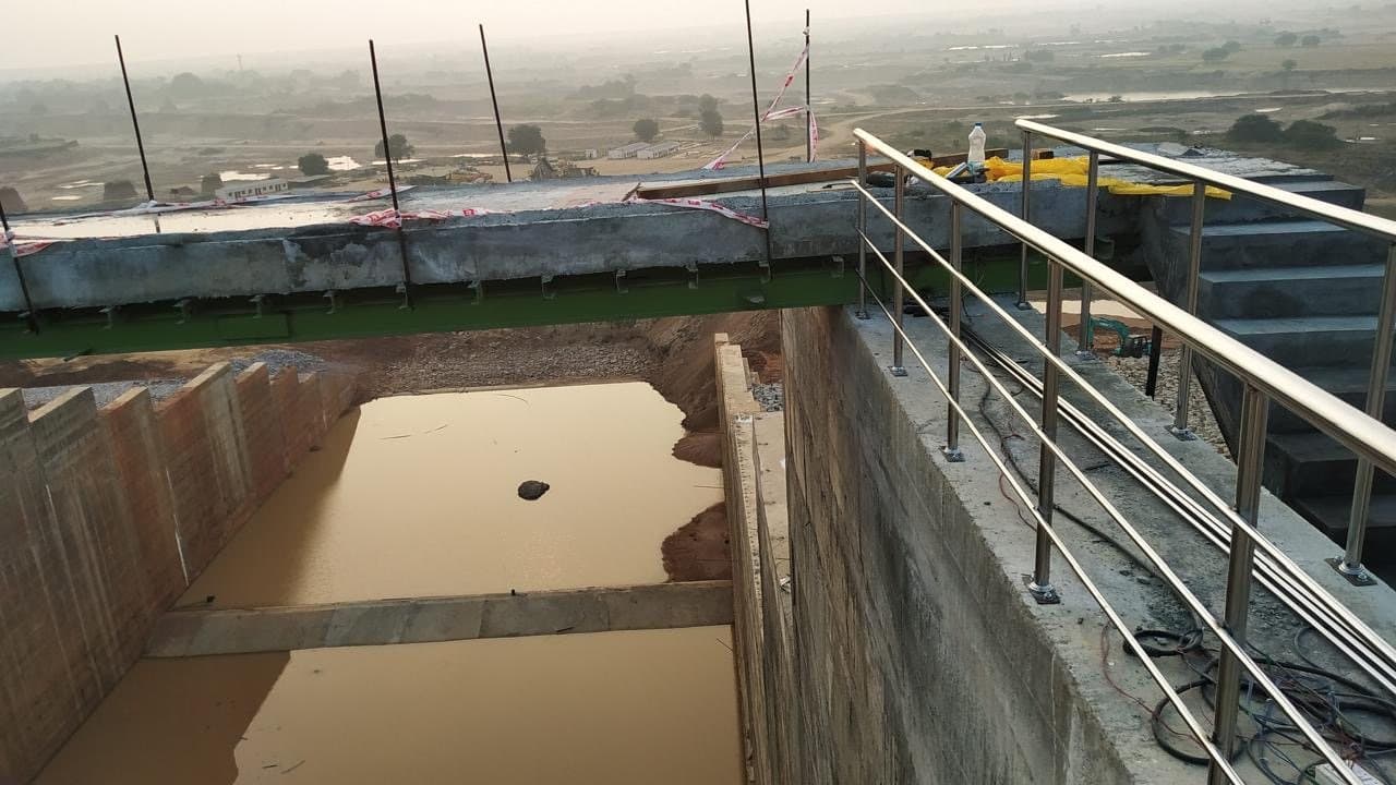 Stainless steel railing along the edge of a water channel